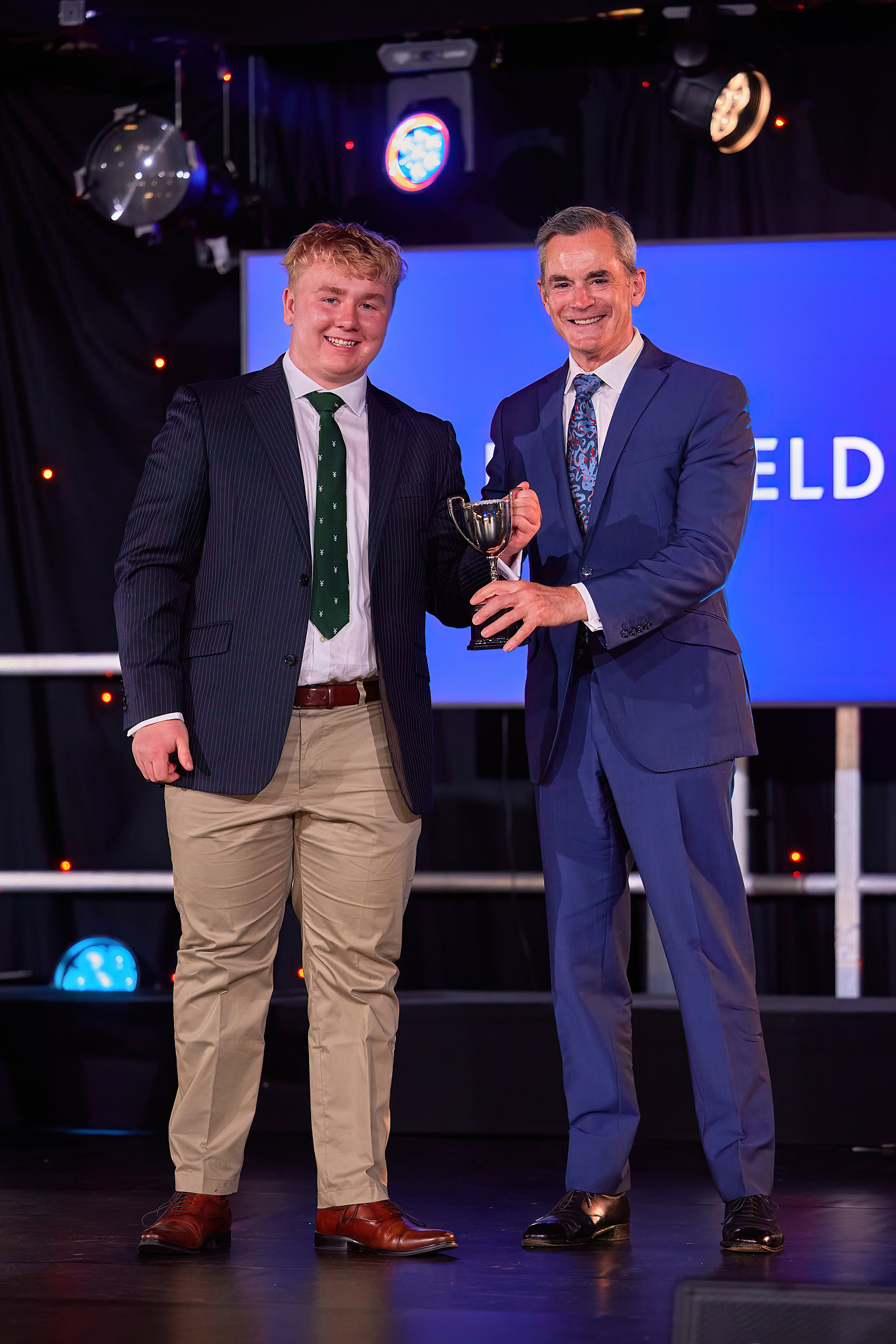 Freddie Beasley collecting an award at Millfield